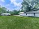 Spacious backyard with a well-maintained lawn, detached garage, and additional structures at 2660 Birch Se St, Smyrna, GA 30080
