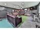 Finished basement with unique dark walls, leather furniture, and faux grass accents at 2660 Birch Se St, Smyrna, GA 30080