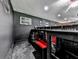 Finished basement with dark walls featuring a viewing area at the top of the steps at 2660 Birch Se St, Smyrna, GA 30080