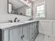 Bathroom featuring a double sink vanity, granite counters, and decorative cabinets at 2660 Birch Se St, Smyrna, GA 30080