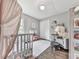 Cozy bedroom featuring a crib, white wooden floors and plenty of natural light at 2660 Birch Se St, Smyrna, GA 30080