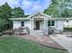 Charming home with stone accents, shutters, a rocking chair, and beautiful landscaping at 2660 Birch Se St, Smyrna, GA 30080