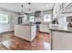 Bright kitchen featuring a center island, stainless steel appliances, white cabinets, and granite countertops at 2660 Birch Se St, Smyrna, GA 30080