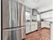 Bright kitchen with stainless steel refrigerator, white cabinets, granite countertops, and tile backsplash at 2660 Birch Se St, Smyrna, GA 30080