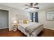Bedroom with a tufted headboard, ceiling fan, hardwood floors and decor at 3250 North Embry Cir, Chamblee, GA 30341