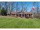 Charming brick ranch home with manicured lawn, mature trees, and welcoming front porch at 3250 North Embry Cir, Chamblee, GA 30341