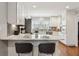 Open kitchen features granite countertops, stainless appliances, white cabinetry, and a breakfast bar at 3250 North Embry Cir, Chamblee, GA 30341