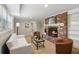 Cozy living room featuring brick fireplace, neutral carpet, and ample seating at 3250 North Embry Cir, Chamblee, GA 30341