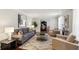 Cozy living room with a gray sofa, two chairs, and hardwood flooring at 3250 North Embry Cir, Chamblee, GA 30341