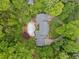 Aerial view of a house with a pool, surrounded by lush greenery and trees at 357 Breeze Hill Ln, Canton, GA 30114
