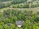 Aerial view of a home nestled among trees, near a golf course, offers a secluded retreat at 357 Breeze Hill Ln, Canton, GA 30114