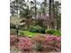 Beautiful backyard featuring lush greenery, colorful flowering shrubs, and mature trees at 357 Breeze Hill Ln, Canton, GA 30114