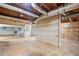Unfinished basement with exposed ductwork, shelving, and access to garage at 357 Breeze Hill Ln, Canton, GA 30114