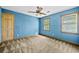 This bedroom features blue walls, natural light, and neutral carpeting at 357 Breeze Hill Ln, Canton, GA 30114