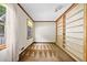 Bright bedroom with built in shelving, carpet, and a window looking out to the yard at 357 Breeze Hill Ln, Canton, GA 30114