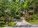 Inviting home exterior with a winding driveway and beautiful mature trees at 357 Breeze Hill Ln, Canton, GA 30114