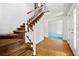 Bright foyer featuring a staircase, hardwood floors, and an entryway to another room at 357 Breeze Hill Ln, Canton, GA 30114