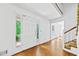 Bright foyer featuring hardwood floors, a staircase, and a view of the front porch at 357 Breeze Hill Ln, Canton, GA 30114