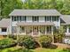 Inviting front elevation with a covered porch, brick accents, and manicured landscaping at 357 Breeze Hill Ln, Canton, GA 30114