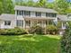 Beautifully landscaped front yard with a two-story home featuring blue shutters and a welcoming porch at 357 Breeze Hill Ln, Canton, GA 30114
