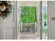 View from inside looking out to the covered front porch with flowers and greenery at 357 Breeze Hill Ln, Canton, GA 30114