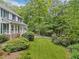 Well-manicured front yard, porch, and lush, mature foliage at 357 Breeze Hill Ln, Canton, GA 30114