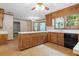 Spacious kitchen featuring wood cabinets, white countertops, tile flooring, and ample natural light at 357 Breeze Hill Ln, Canton, GA 30114