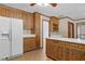 Traditional kitchen with wooden cabinets, white refrigerator and tile flooring at 357 Breeze Hill Ln, Canton, GA 30114
