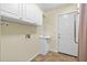 Functional laundry room with white cabinets and a utility sink at 357 Breeze Hill Ln, Canton, GA 30114