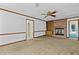 Living room featuring a brick fireplace, carpet flooring, neutral walls, and seamless access to other living spaces at 357 Breeze Hill Ln, Canton, GA 30114