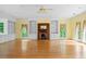 Open living room with hardwood floors, fireplace, built-in shelving and a large set of windows at 357 Breeze Hill Ln, Canton, GA 30114