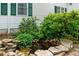 Exterior shot showing a small backyard pond surrounded by rocks and lush greenery at 357 Breeze Hill Ln, Canton, GA 30114