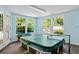 Indoor pool room with light blue walls, a hot tub, wood floors, and large picture windows at 357 Breeze Hill Ln, Canton, GA 30114