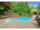 Backyard pool with concrete surround and mature trees at 357 Breeze Hill Ln, Canton, GA 30114