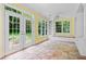 Sunny sun room with tiled floor and double doors leading to the outside at 357 Breeze Hill Ln, Canton, GA 30114
