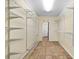 Large walk-in closet features shelving, tile flooring, and a door at 357 Breeze Hill Ln, Canton, GA 30114