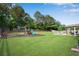 Lush backyard features a playset, fire pit area, and covered patio, creating an inviting outdoor space at 4285 Hunters Walk Way, Cumming, GA 30028