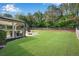 Large, well-manicured backyard features a covered patio, fire pit, and playset, perfect for outdoor entertaining at 4285 Hunters Walk Way, Cumming, GA 30028