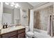 Bathroom featuring granite countertops, tile shower, and brushed nickel hardware at 4285 Hunters Walk Way, Cumming, GA 30028