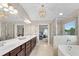 Luxurious bathroom featuring dual sinks, soaking tub, and glass enclosed shower at 4285 Hunters Walk Way, Cumming, GA 30028