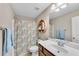 Full bathroom featuring a sink, vanity, toilet, and a shower with a patterned curtain at 4285 Hunters Walk Way, Cumming, GA 30028