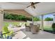 Covered patio with a ceiling fan, outdoor furniture, and a view of the landscaped backyard at 4285 Hunters Walk Way, Cumming, GA 30028