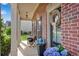 Charming front porch with brick accents, cozy seating, and blue hydrangeas offers a welcoming curb appeal at 4285 Hunters Walk Way, Cumming, GA 30028