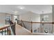 Upstairs hallway features neutral colors, carpeting, and wrought iron railing at 4285 Hunters Walk Way, Cumming, GA 30028
