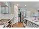 Modern kitchen with stainless steel appliances, hardwood floors, and light blue cabinets at 4285 Hunters Walk Way, Cumming, GA 30028