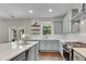 Bright kitchen with a large island, stainless steel appliances, and access to outdoor patio area at 4285 Hunters Walk Way, Cumming, GA 30028