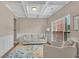 Cozy living room with coffered ceilings, large window, and comfortable seating arrangement at 4285 Hunters Walk Way, Cumming, GA 30028