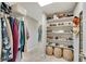 Spacious walk-in closet with shelving for shoes and hanging clothes, perfect for organization at 4285 Hunters Walk Way, Cumming, GA 30028