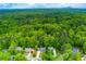 Aerial view showcases the wooded neighborhood, surrounding greenery, and community at 2249 Hill Creek Way, Marietta, GA 30062