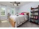 Inviting bedroom boasts natural light and shelving with charming personal touches at 2249 Hill Creek Way, Marietta, GA 30062